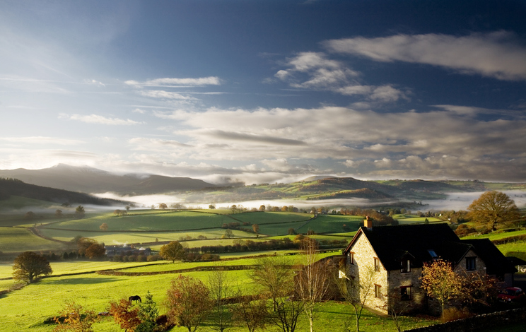 a rural house on a misty morning