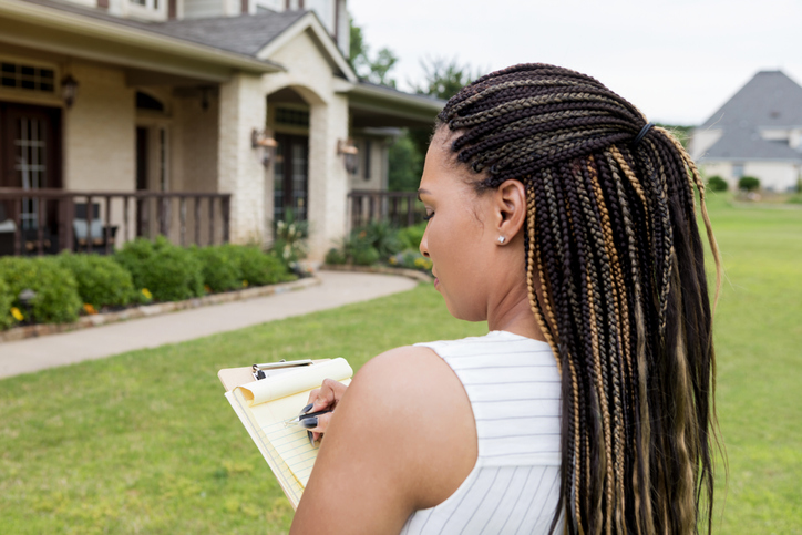 Mid adult Real Estate Agent evaluates a property for sale