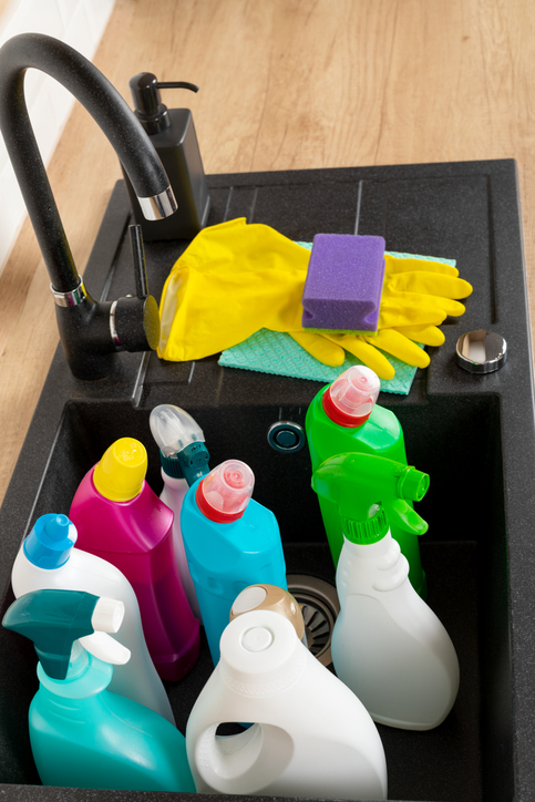 Colorful cleaning products in the kitchen sink