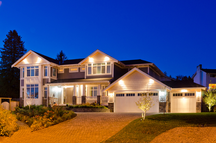 Luxury house at dusk lit up with lights