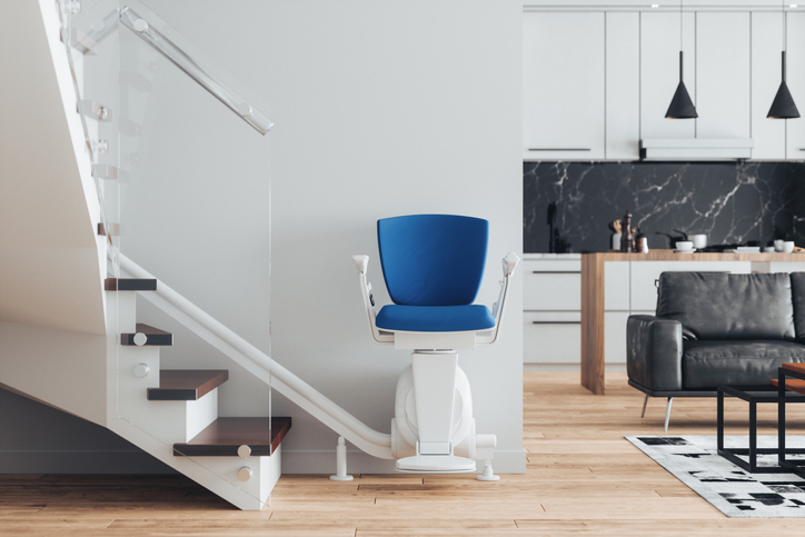 Automatic stair lift on staircase in a modern luxury home.