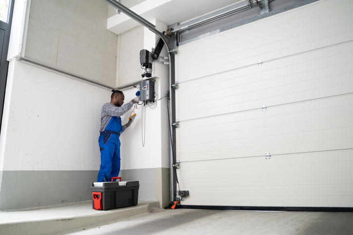 Garage Door Installation And Repair At Home. Contractor Man In House